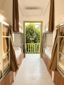 a hallway with a door into a room with a window at White Elephant Hostel in Luang Prabang
