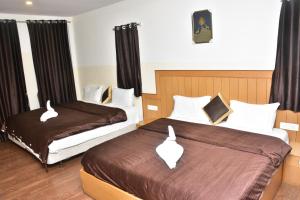 Ένα ή περισσότερα κρεβάτια σε δωμάτιο στο Magizham Homestay