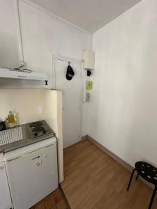 a small kitchen with a stove and a refrigerator at Bright apartment, 5 minutes from Paris in Asnières-sur-Seine
