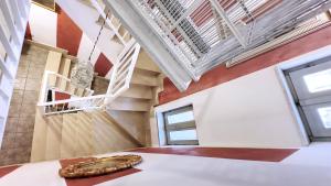 a snake sitting on a table in a room with a staircase at Casetta La Rubiconda in Asti +50 photos