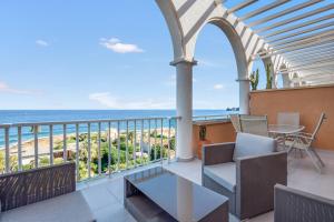 a balcony with a view of the ocean at Jávea Beachfront Penthouse in Platja de l'Arenal