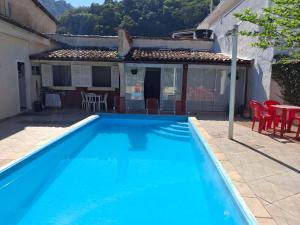 een groot blauw zwembad voor een huis bij casa dos MORAIS in Angra dos Reis +5 foto's
