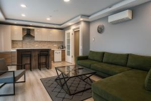a living room with a green couch and a table at On4 Rooms & Suites in Istanbul