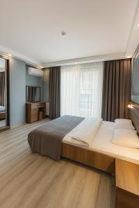 Postel nebo postele na pokoji v ubytování On4 Rooms & Suites