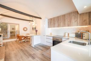 a kitchen with white countertops and a dining room at Guest Ready - Charming Retreat in Palmela in Palmela +26 photos