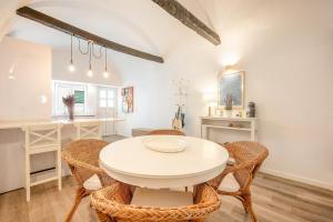 a kitchen and dining room with a white table and chairs at Guest Ready - Charming Retreat in Palmela in Palmela
