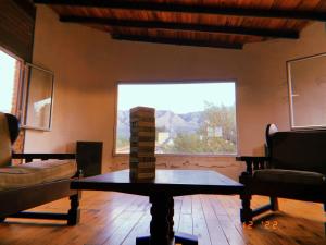 a living room with a table and a large window at El Ventanal in Las Rabonas