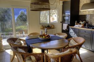 a kitchen with a table with a bowl of fruit on it at L'aire in Lantosque