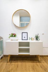 a white dressing table with a mirror on the wall at NOMADIA en LARIOS STREET in Málaga +11 photos