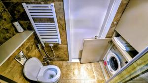 a bathroom with a toilet and a washing machine at Billionare by Alliance Palace in Batumi +17 photos