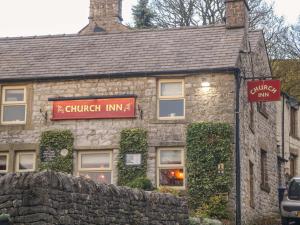 a stone building with a church inn sign on it at Little Thornsett in Buxton