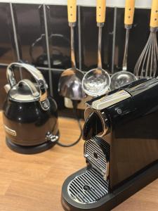 a toaster and a tea pot and utensils on a table at Hildes Bett in Aschersleben
