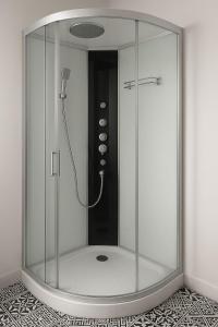 a shower with a glass enclosure in a bathroom at Comfortable house in Oliena
