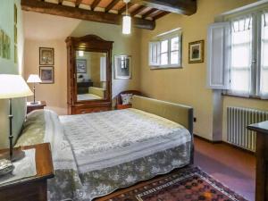 a bedroom with a bed and a table and a mirror at Apartment With Terrace And Pool Near Lucca in San Quirico di Moriano