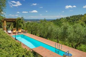 an outdoor swimming pool with a view of the trees at Apartment With Terrace And Pool Near Lucca in San Quirico di Moriano