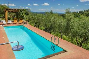 a swimming pool with a view of the trees at Apartment With Terrace And Pool Near Lucca in San Quirico di Moriano +22 photos