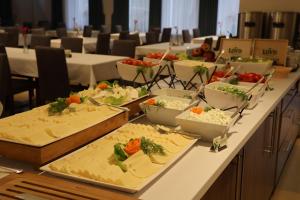 a long table with many plates of food on it at Sanatorium Gryf in Połczyn-Zdrój +2 photos