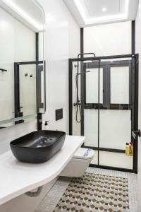 a bathroom with a black tub on a counter at NOMADIA en Plaza de la Constitucion 1 in Málaga