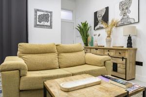 a living room with a couch and a coffee table at NOMADIA en Plaza de la Constitucion 1 in Málaga +10 photos