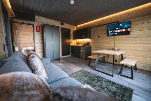 a living room with a couch and a table at Aurora Hill Resort, Rovaniemi in Rovaniemi