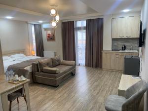 a large hotel room with a bed and a couch at Hotel K124 in Kutaisi