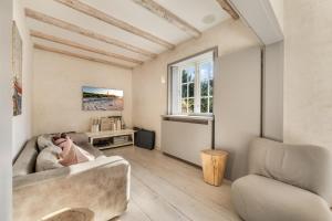 a living room with a couch and a chair at Lighthouse 2 in Hörnum