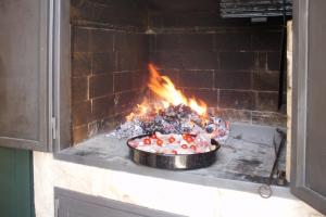 a pie in an oven with fire in it at Apartments by the sea Cove Donja Kruscica - Donja Krusica, Solta - 11146 in Grohote
