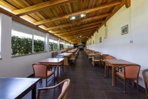 a row of tables and chairs in a restaurant at Apartments by the sea Sucuraj, Hvar - 3589 in Sućuraj