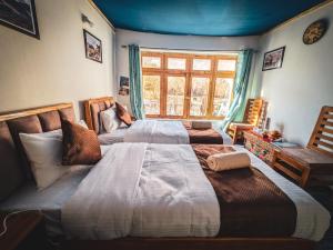 Ένα ή περισσότερα κρεβάτια σε δωμάτιο στο Siachen Eco Residence +5 φωτογραφίες