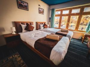 Ένα ή περισσότερα κρεβάτια σε δωμάτιο στο Siachen Eco Residence