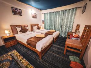 Ένα ή περισσότερα κρεβάτια σε δωμάτιο στο Siachen Eco Residence