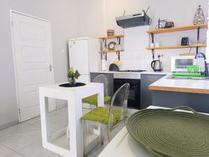 a kitchen with a small white table and chairs at Serubi Cottage in Gaborone