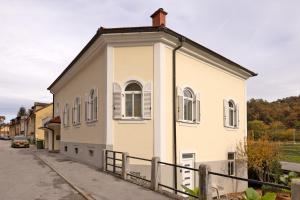 a white building with windows on a street at Apartment Arc 23 in Celje