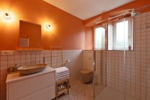 a bathroom with a sink and a shower at Apartment Arc 23 in Celje