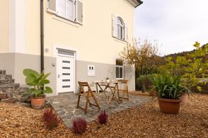 a patio with a table and chairs in front of a house at Apartment Arc 23 in Celje