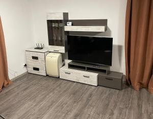 a living room with a flat screen tv on a entertainment center at Райска тишина in Zlatitsa