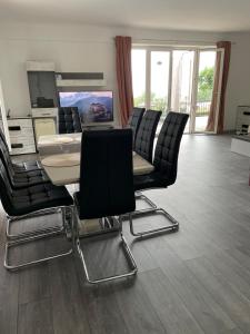 a salon with a table and chairs in a room at Райска тишина in Zlatitsa