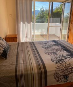 a bedroom with a bed and a large window at Райска тишина in Zlatitsa +75 photos