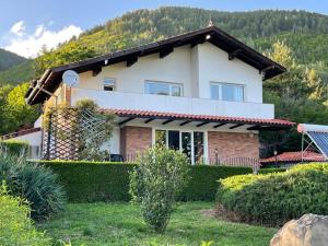 a house with a mountain in the background at Райска тишина in Zlatitsa