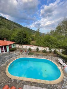 a swimming pool in a yard with a mountain in the background at Райска тишина in Zlatitsa