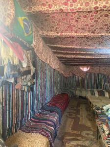 Una habitación con un montón de almohadas en una pared. en Saint Catherine Camp & Lodge - Moses Mountain Sinai Tours, en Saint Catherine