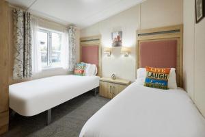 Ένα ή περισσότερα κρεβάτια σε δωμάτιο στο Primrose Lodge with Hot Tub