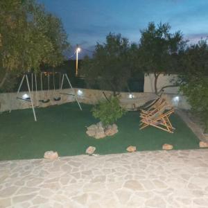 a backyard with a hammock and a swing at Holiday house with a parking space Drvenik , Drvenik - 24088 in Dolići