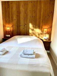 a bedroom with a bed with two towels on it at Houseboat Sneek in Sneek +1 photo