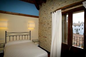 a bedroom with a bed and a window at El Faixero Tradicional in Cinctorres