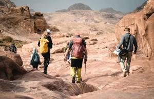 un grupo de personas caminando por el desierto en Saint Catherine Camp & Lodge - Moses Mountain Sinai Tours, en Saint Catherine