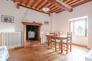 a dining room with a table and a fireplace at Il Tinaio di Mary in Cetona