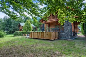 a log cabin with a deck and a balcony at Holiday house with a swimming pool Brod na Kupi, Gorski kotar - 23012 in Brod na Kupi