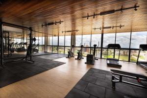 a gym with several treadmills and a large window at Estúdios modernos no Empiria by WeHousy in Luis Eduardo Magalhaes