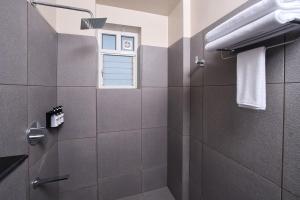 a bathroom with a shower and a window at MYSA Sky Suites, Lakkidi in Vythiri